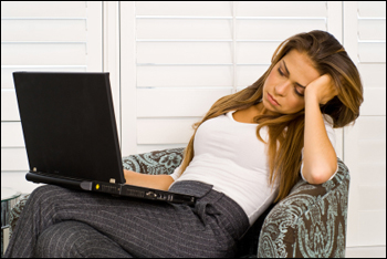 Image of business woman staring into laptop.